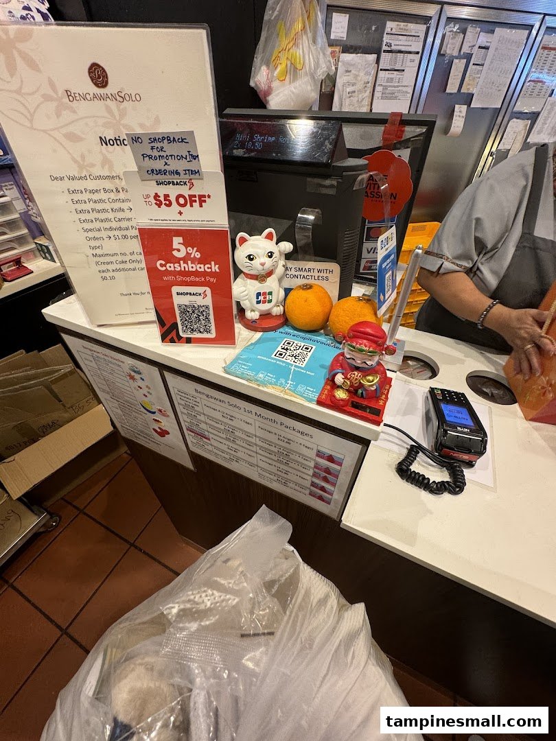A busy checkout counter at Bengawan Solo, featuring payment options and promotional offers.
