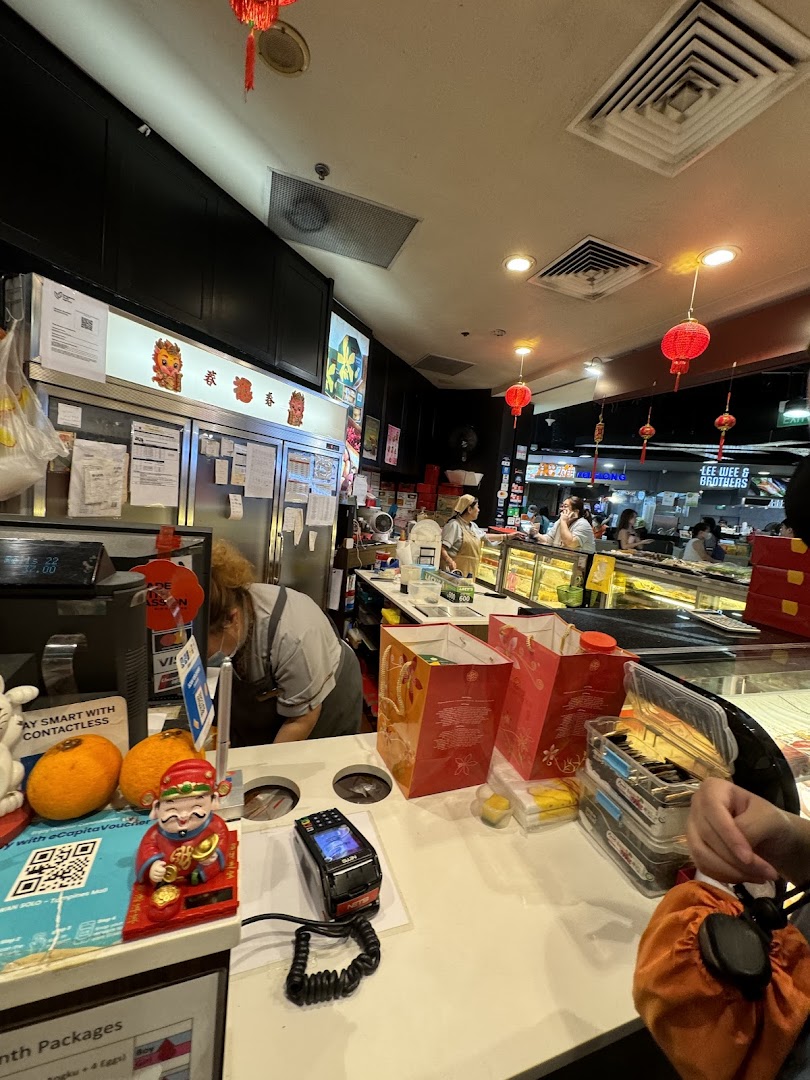 Interior view of Bengawan Solo's counter area, showing staff, products, and festive decorations.