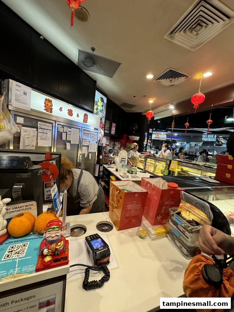 Interior view of Bengawan Solo's counter area, showing staff, products, and festive decorations.