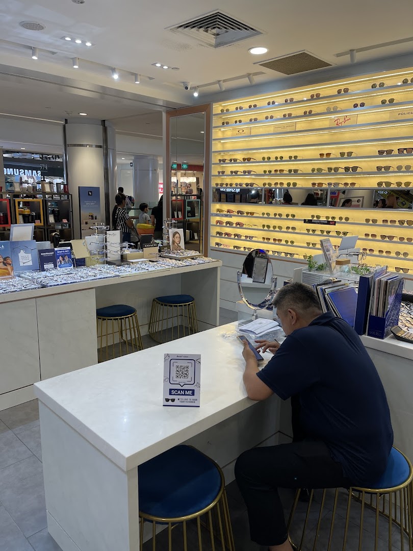 Interior view of Better Vision optical shop, showcasing eyewear displays and a customer.