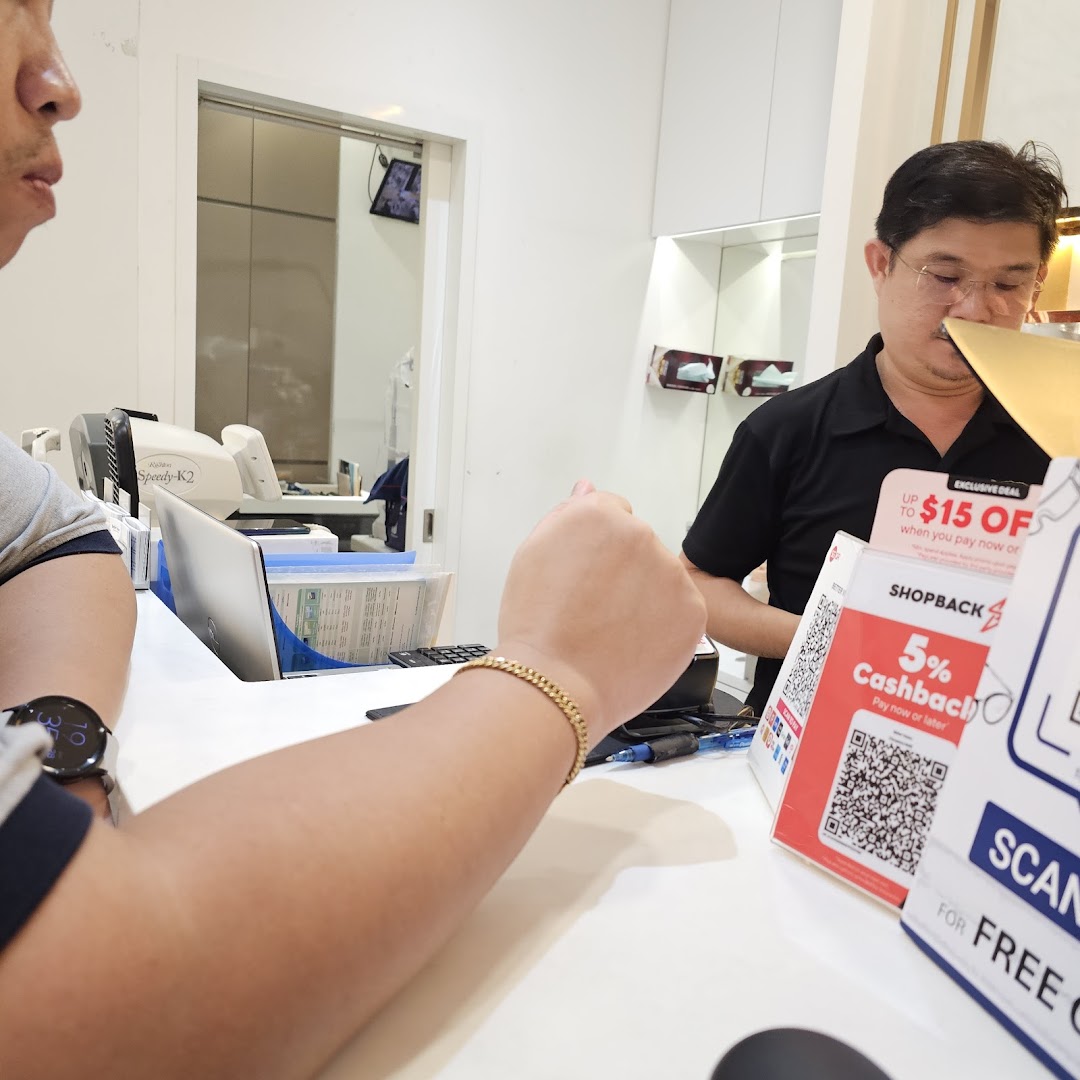 A customer interacts with a staff member at the counter of Better Vision, with payment options visible.