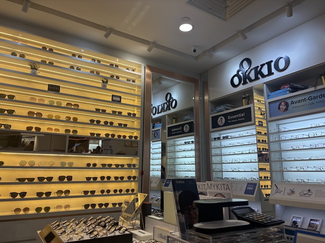 Interior view of Better Vision optical shop showcasing a wide array of stylish eyeglasses and sunglasses on illuminated displays.