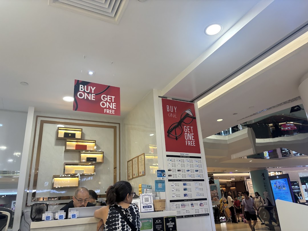 Interior view of Better Vision showing staff, a counter, and prominent 'Buy One Get One Free' promotions.
