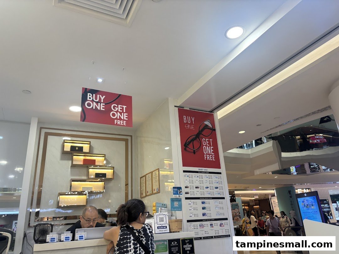 Interior view of Better Vision showing staff, a counter, and prominent 'Buy One Get One Free' promotions.