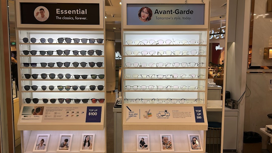Two illuminated display stands showcasing a wide range of stylish eyeglasses and sunglasses at Better Vision.