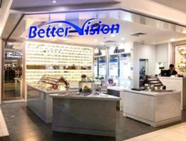 The brightly lit storefront of Better Vision, an optical shop, showcasing a wide array of eyewear.