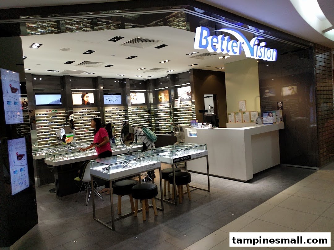 Interior view of Better Vision eyewear shop featuring display cases, a staff member, and reception counter.