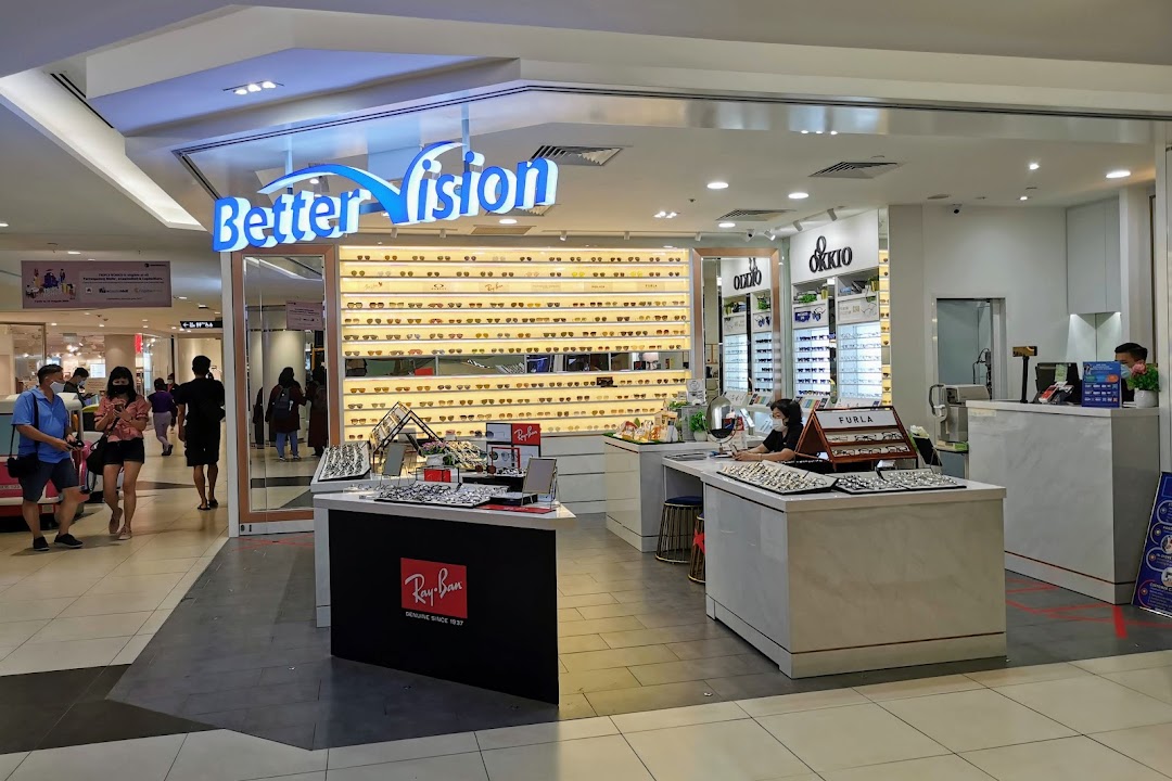 The Better Vision optical shop entrance features extensive eyewear displays and a welcoming counter area.