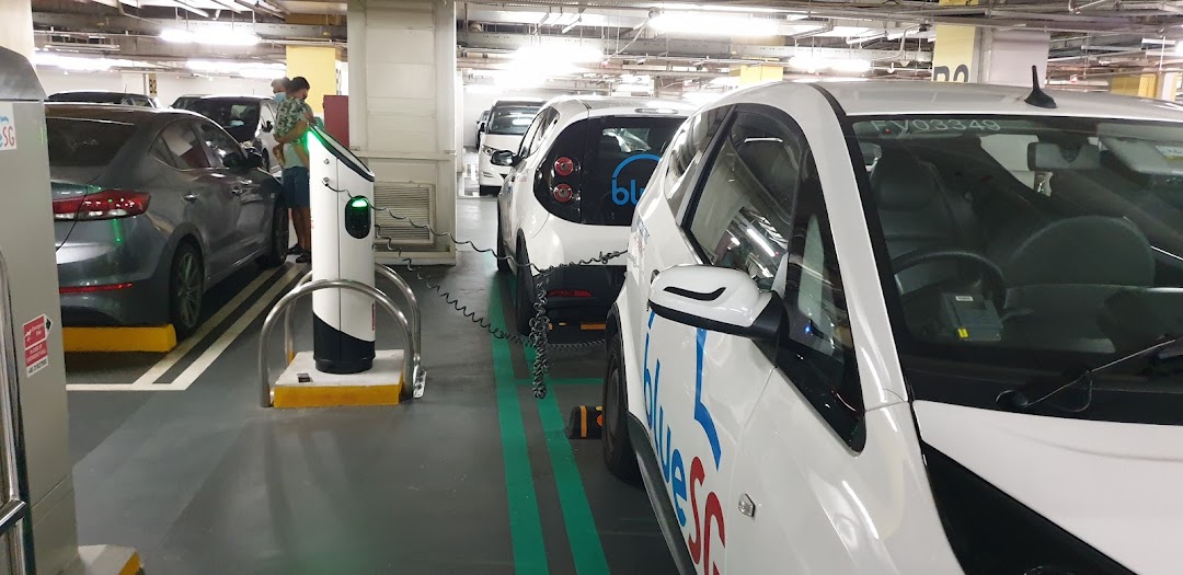 BlueSG electric cars charging at dedicated stations in Tampines Mall's B2 parking deck.