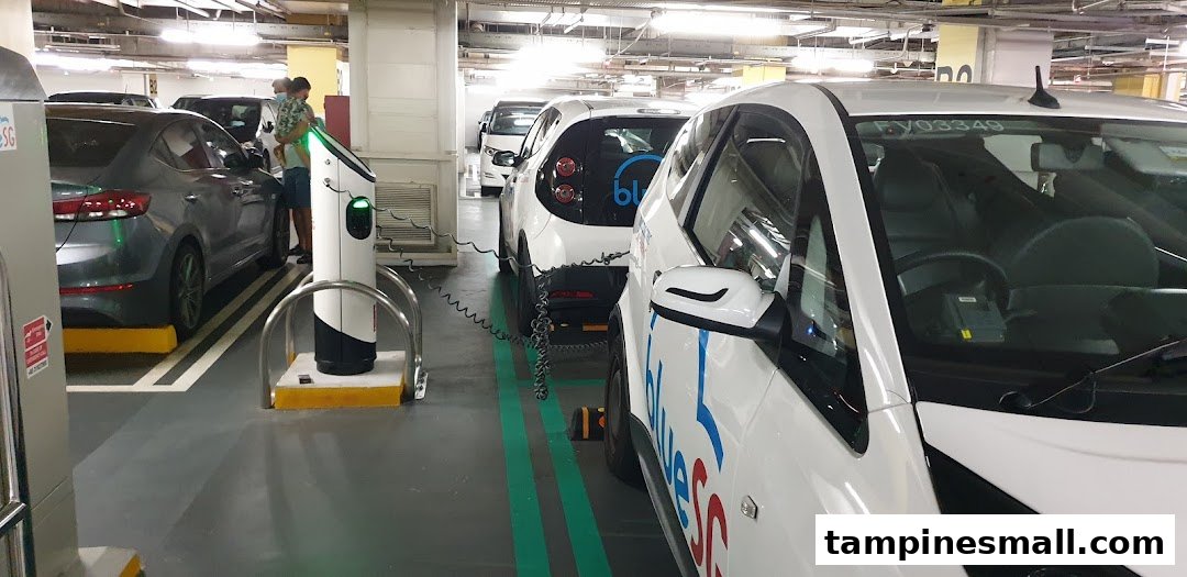 BlueSG electric cars charging at dedicated stations in Tampines Mall's B2 parking deck.