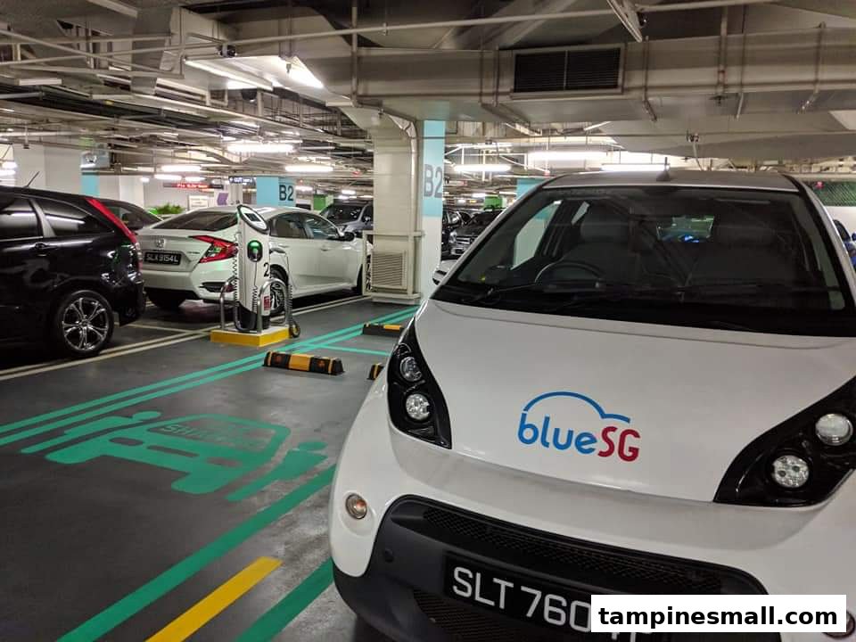 A BlueSG electric car parked at a charging station in Tampines Mall's basement B2 parking lot.