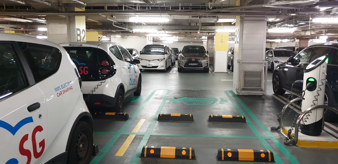 BlueSG electric car sharing vehicles parked and charging in Tampines Mall's B2 parking deck.
