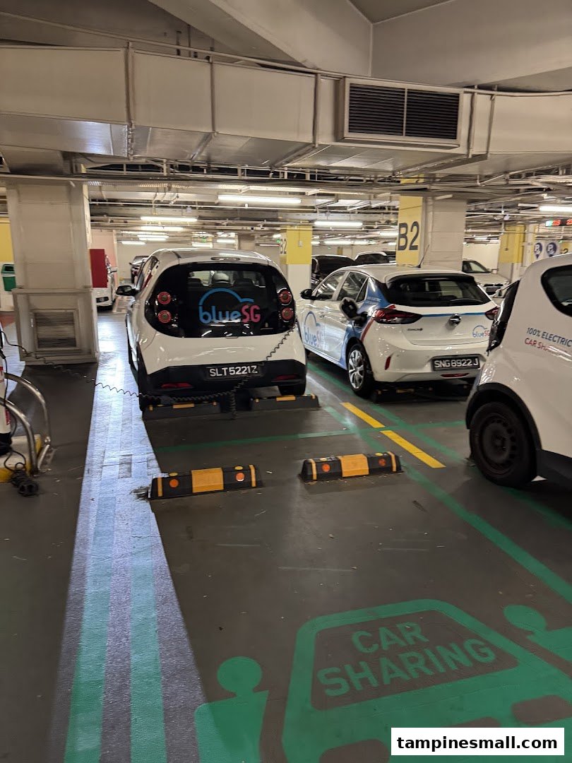 BlueSG electric car sharing vehicles charging in a basement parking lot at Tampines Mall.