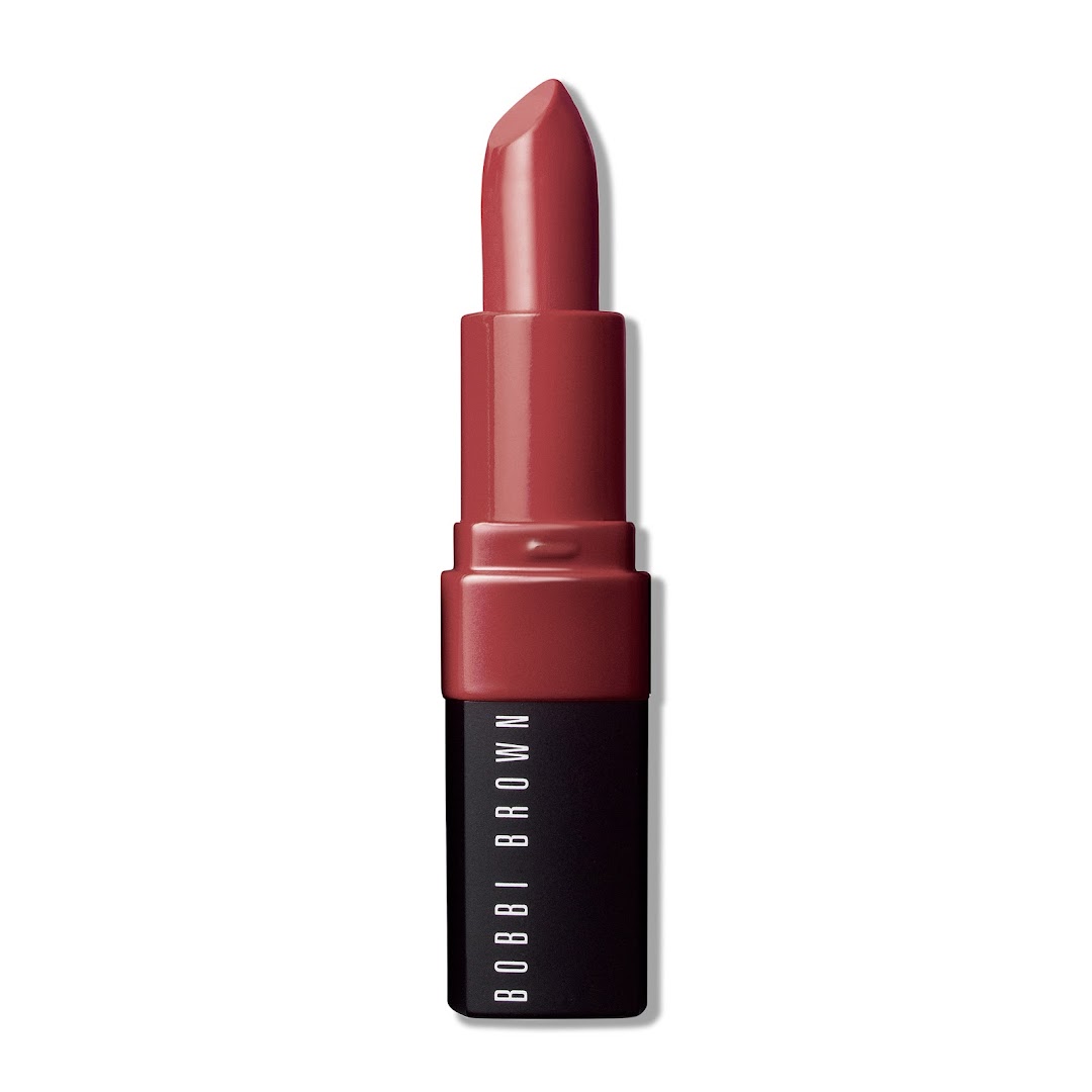 A close-up studio shot of a Bobbi Brown lipstick in a rich red shade.