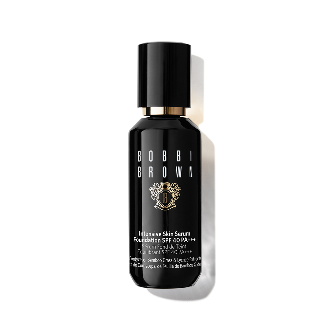 A black Bobbi Brown Intensive Skin Serum Foundation bottle with gold accents on a white background.