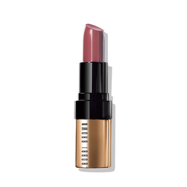 A close-up of a Bobbi Brown lipstick in a rose shade with elegant gold and black packaging.