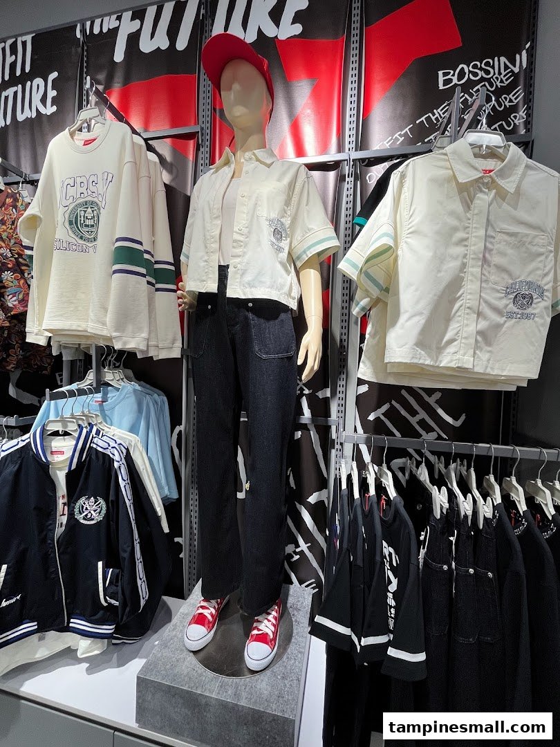 A mannequin displays casual wear, surrounded by clothing racks and a 'BOSSINI' sign in a retail store.