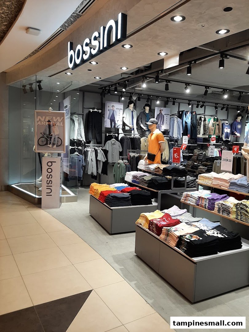 The image captures the inviting entrance and well-lit interior of a Bossini clothing store, showcasing various apparel displays.