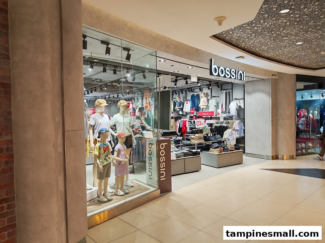 The shop front of Bossini at Tampines Mall, showcasing casual wear on mannequins and a sale display.