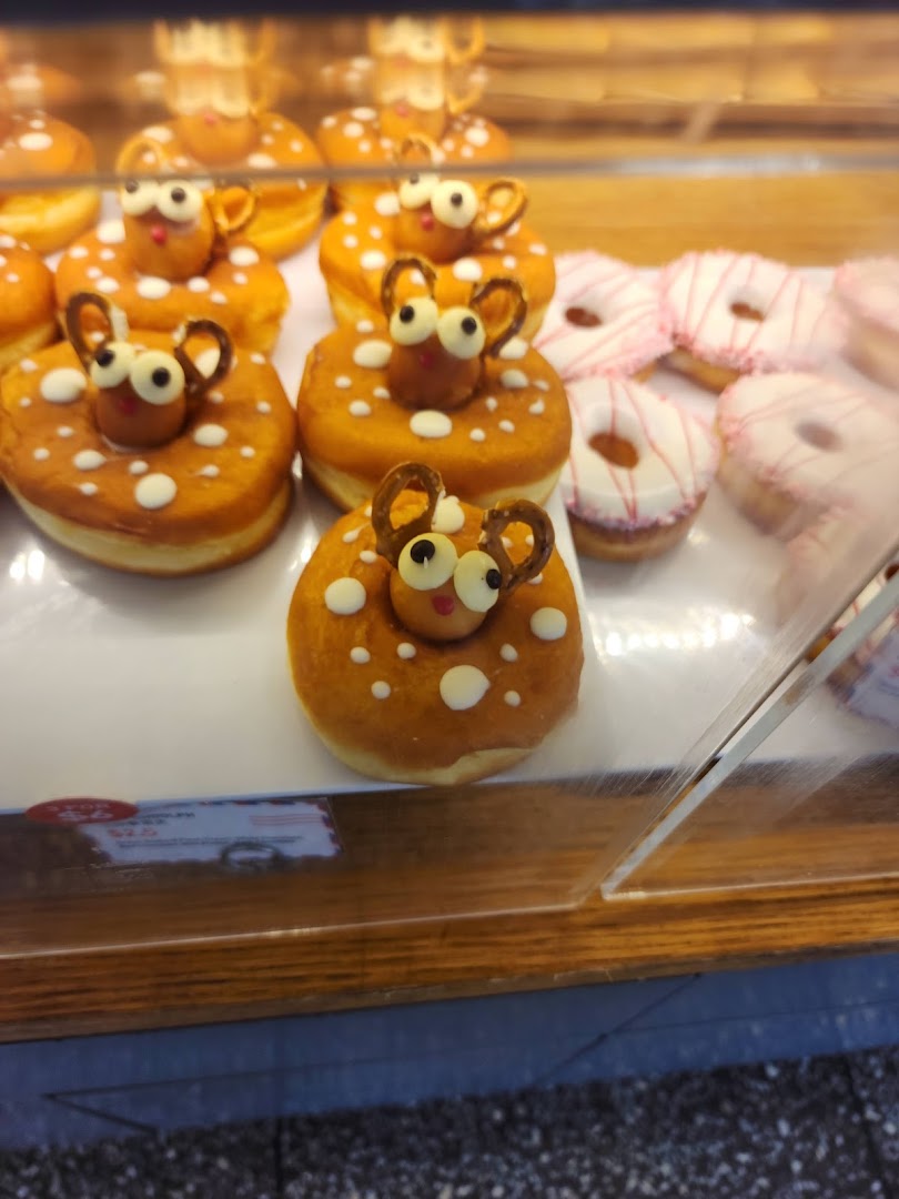 A display case filled with adorable deer-themed donuts and other sweet pastries.
