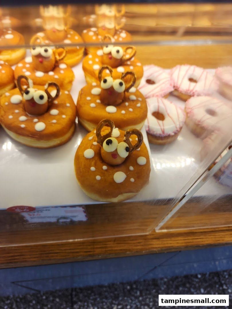 A display case filled with adorable deer-themed donuts and other sweet pastries.