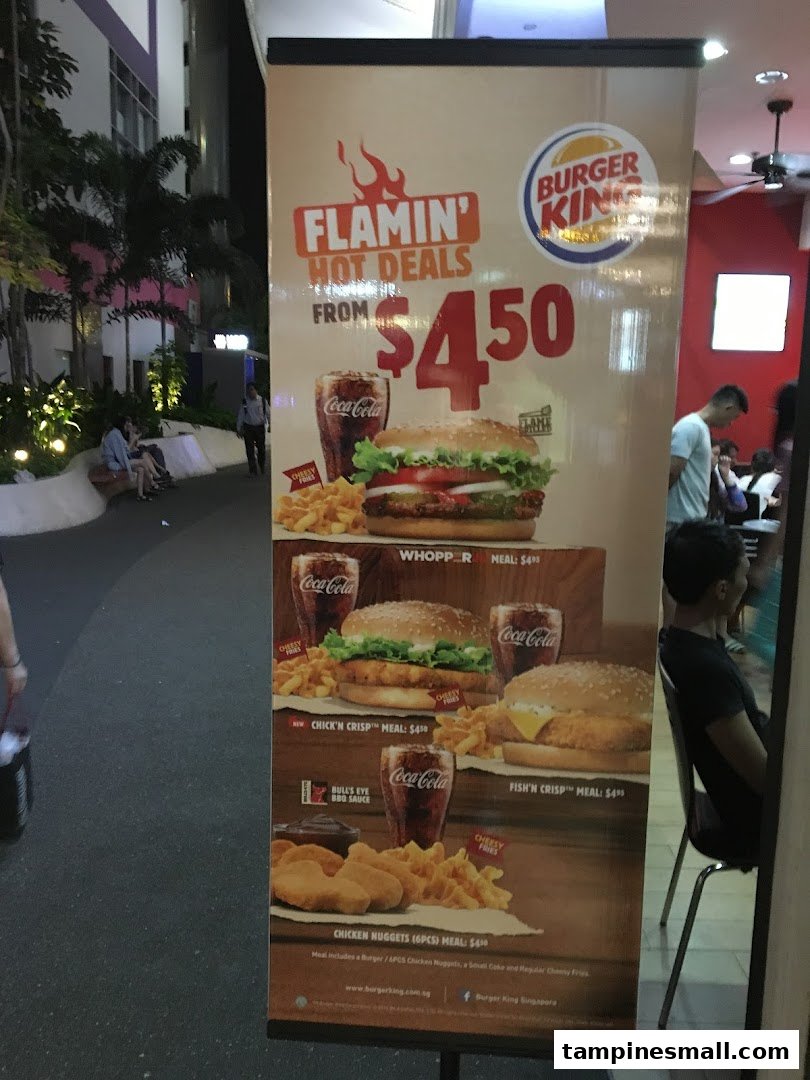 A Burger King promotional banner showcasing 'Flamin' Hot Deals' with various meal options and prices.