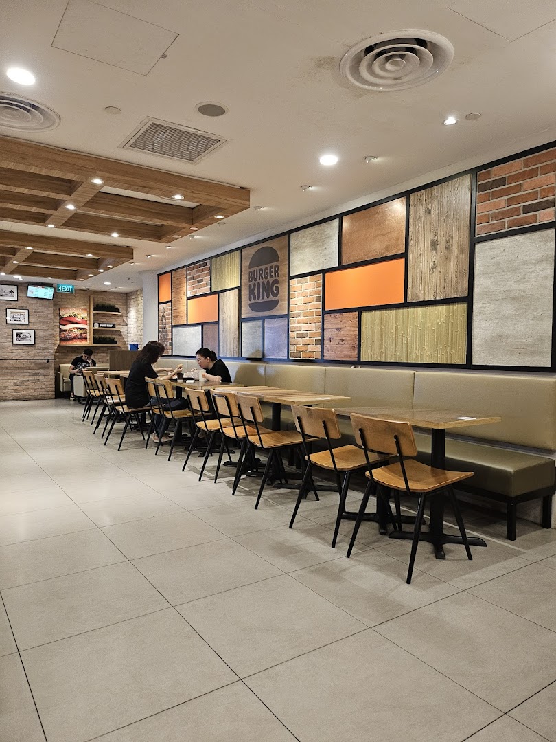 Interior view of Burger King Tampines Mall, featuring modern seating and a decorative wall.