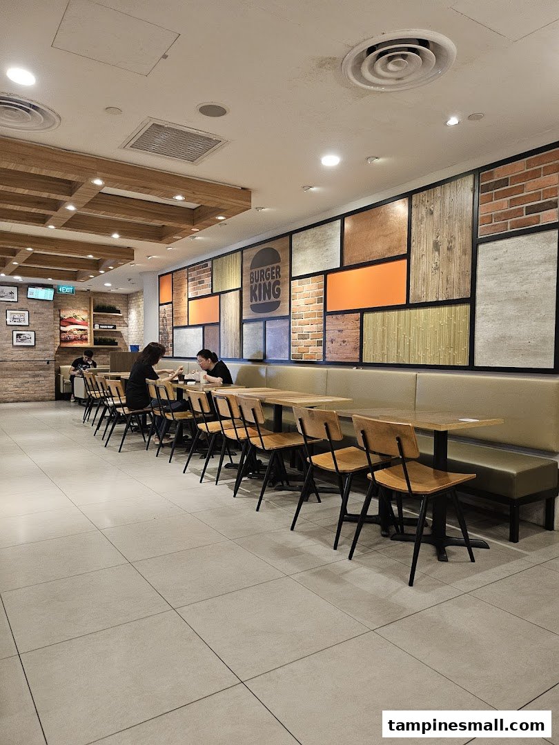 Interior view of Burger King Tampines Mall, featuring modern seating and a decorative wall.