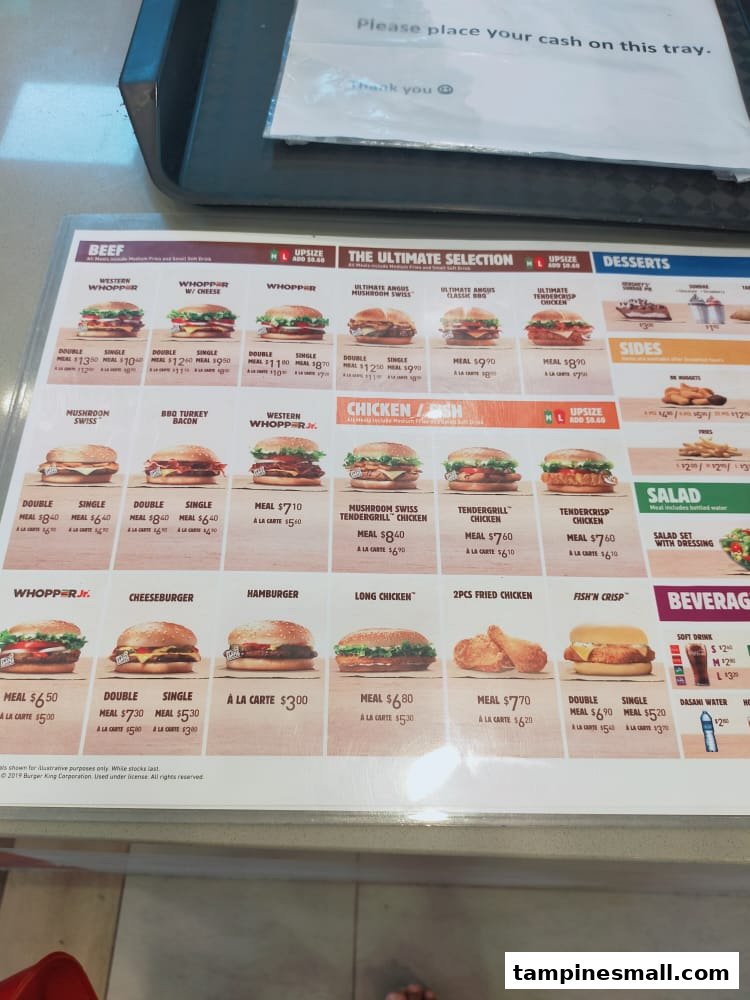 A detailed menu board displaying various burgers, chicken, sides, and beverages with prices.