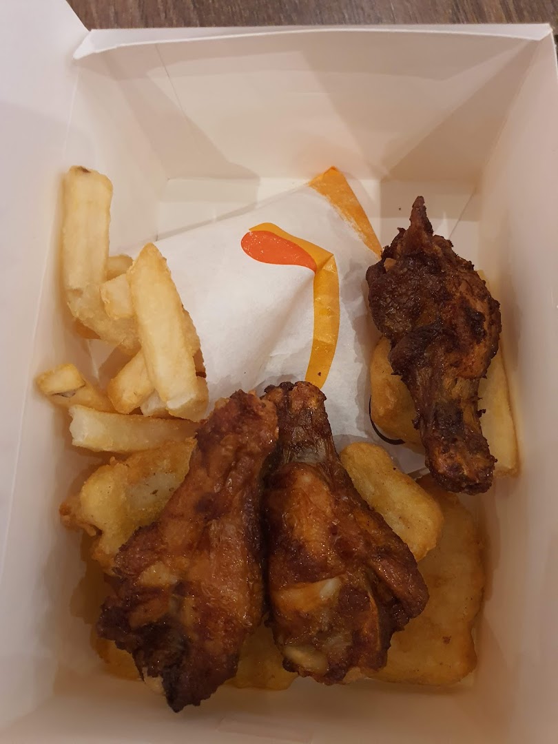 A box of crispy fried chicken pieces and golden fries from Burger King.