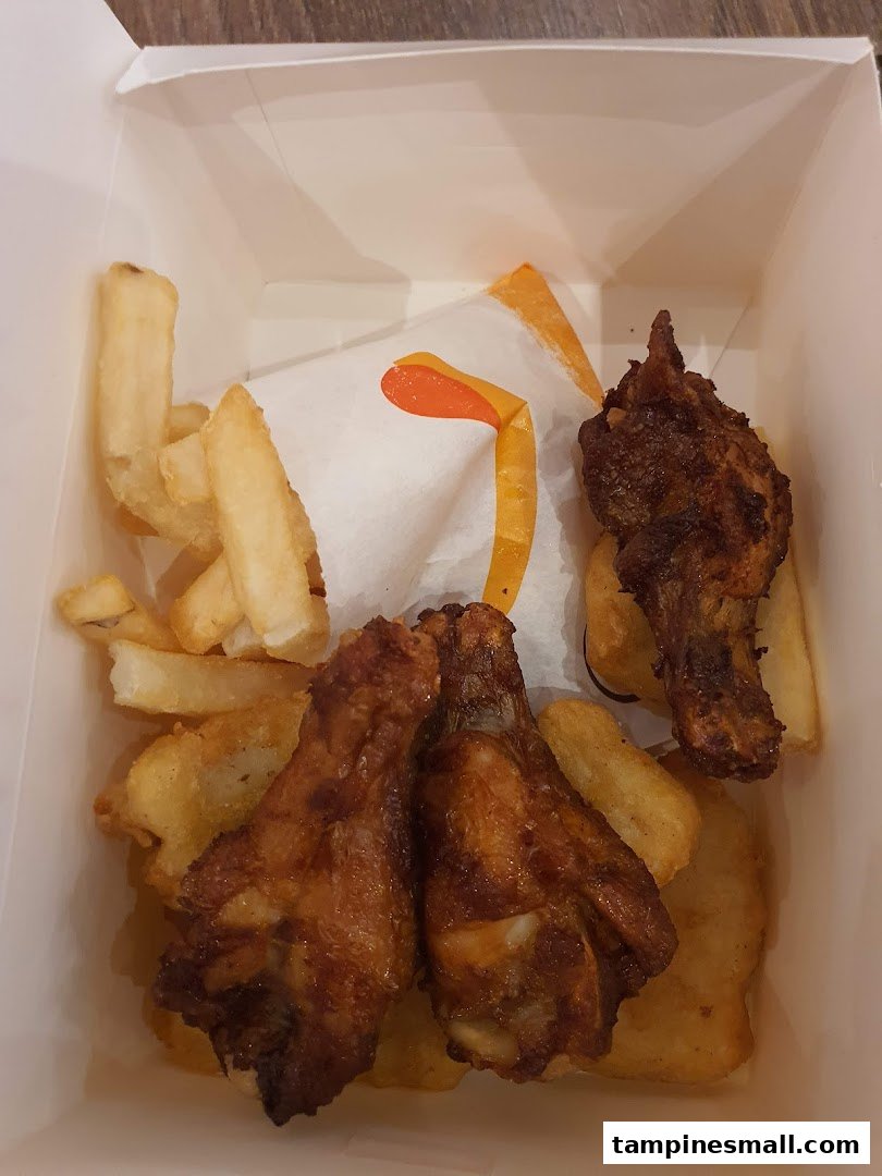 A box of crispy fried chicken pieces and golden fries from Burger King.