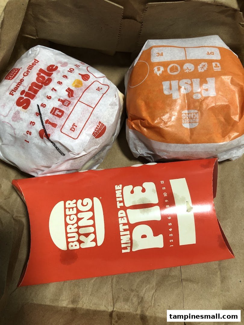 Burger King Flame-Grilled Single, Fish burger, and a Limited Time Pie in a paper bag.