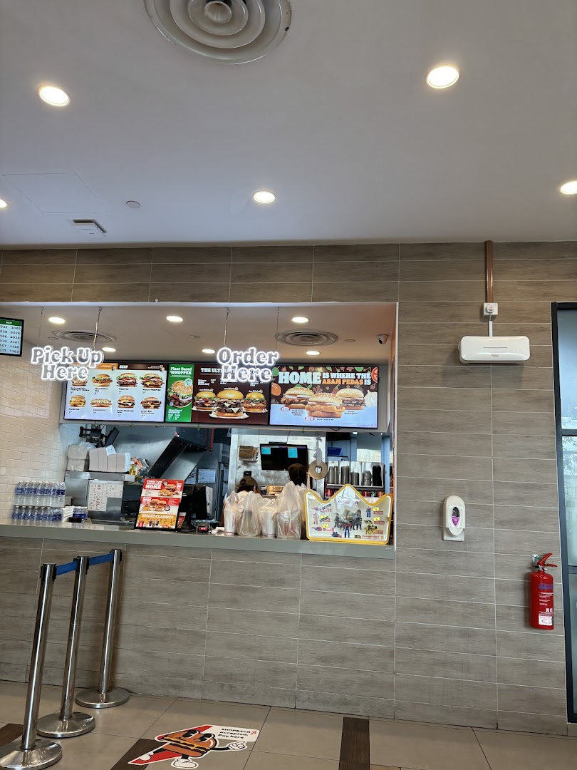 The ordering counter at Burger King Tampines Mall, featuring digital menu boards and queue stanchions.