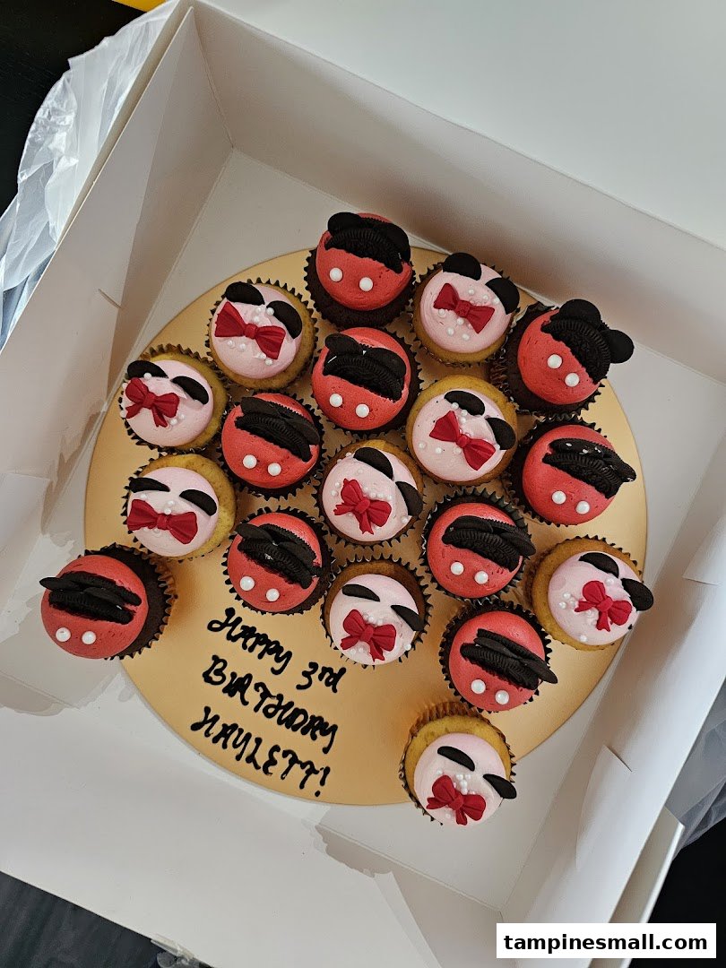 A collection of Mickey and Minnie Mouse themed cupcakes in a box with a 'Happy 3rd Birthday HAYLETT!' message.