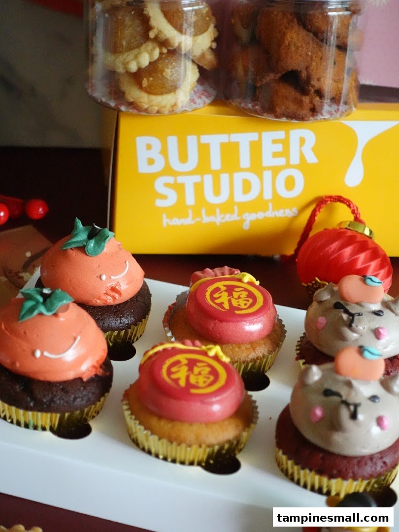 Assorted festive cupcakes and cookies from Butter Studio, featuring unique designs and flavors.