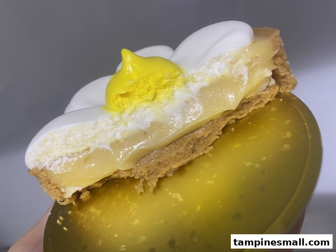 A close-up of a delicious lemon meringue tart with a unique 'fried egg' design.