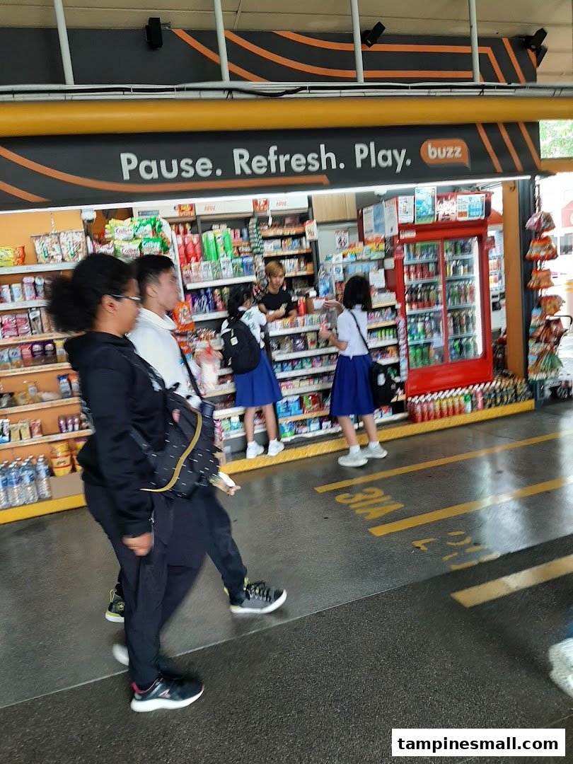 Customers browse snacks and drinks at the Buzz convenience store entrance.