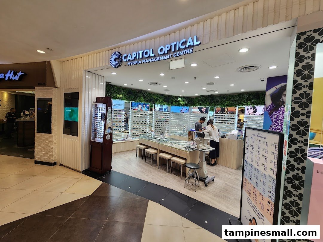The image shows the bright and modern storefront of Capitol Optical, an optical shop with various eyewear displays.