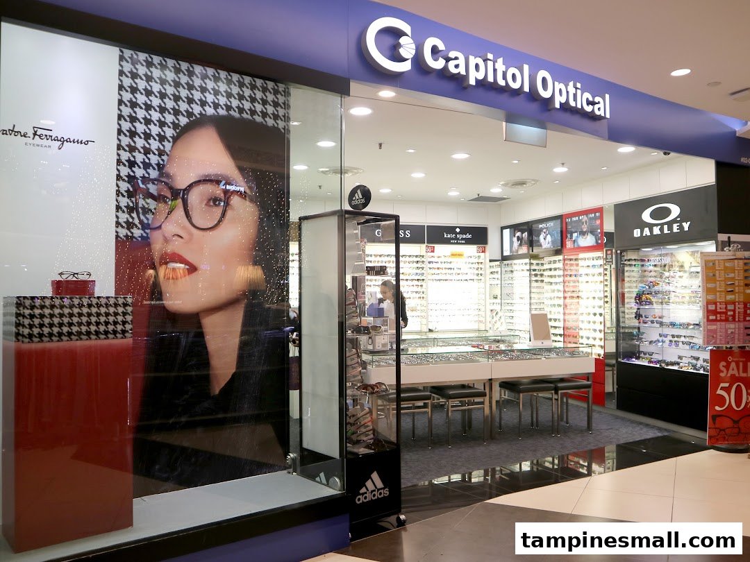 The brightly lit shop front of Capitol Optical, showcasing eyewear displays and promotional visuals.