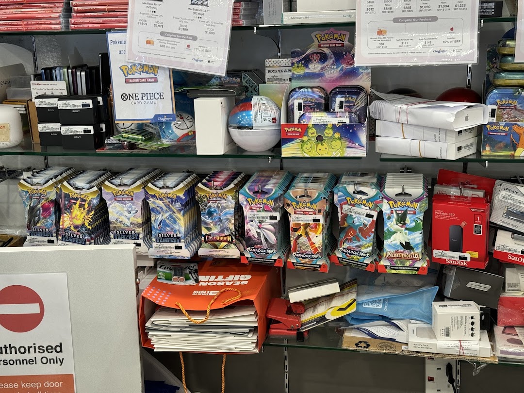 Shelves inside Challenger store displaying Pokémon trading cards, Apple products, and various electronics.
