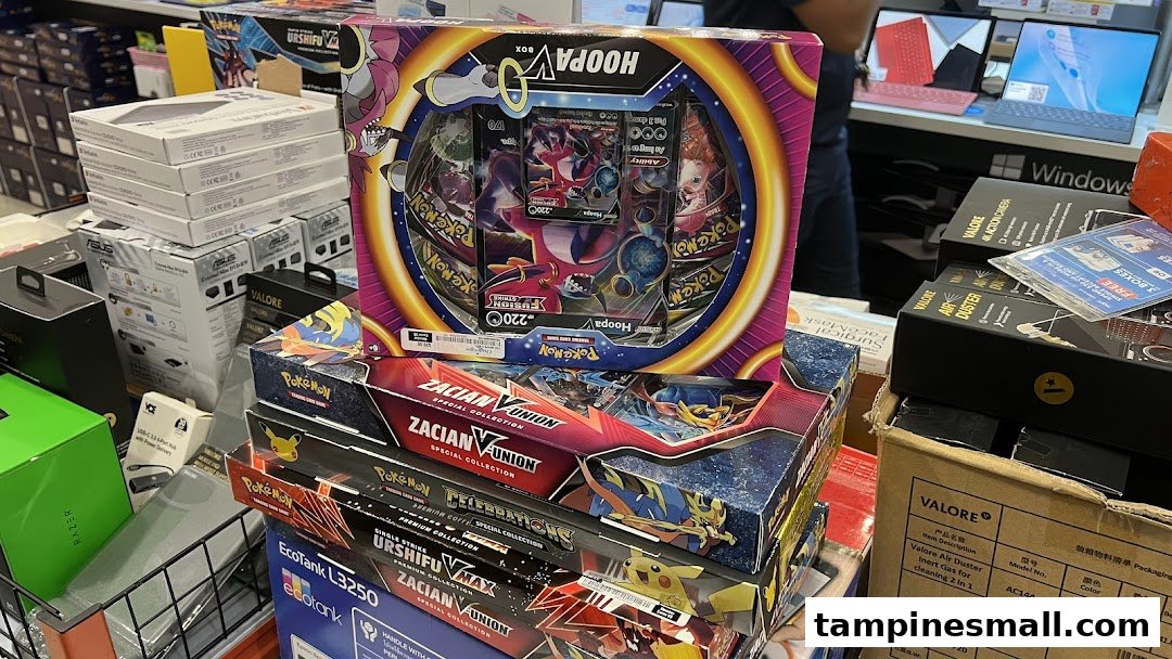 A display of electronics, including Razer products, and various Pokémon Trading Card Game boxes at Challenger.