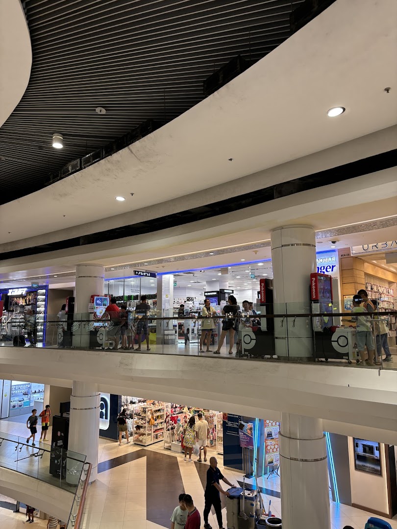 A multi-level view of Challenger and other shops within Tampines Mall, bustling with shoppers.