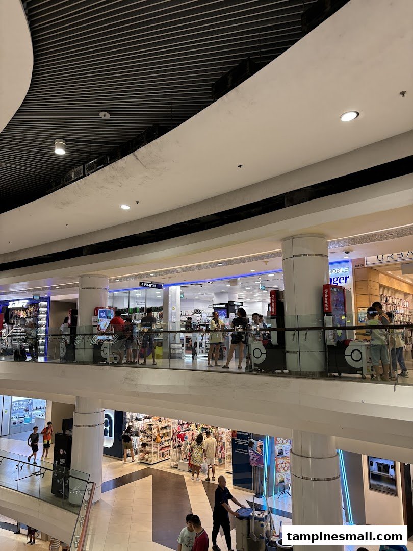 A multi-level view of Challenger and other shops within Tampines Mall, bustling with shoppers.