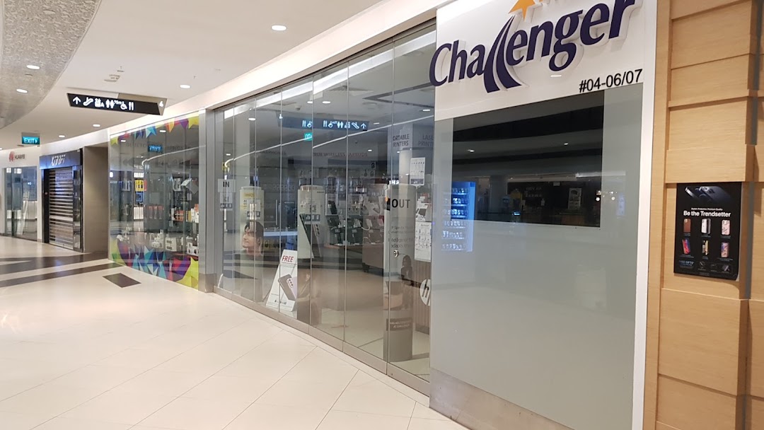 The glass storefront of Challenger, an electronics and IT store, located in a shopping mall.