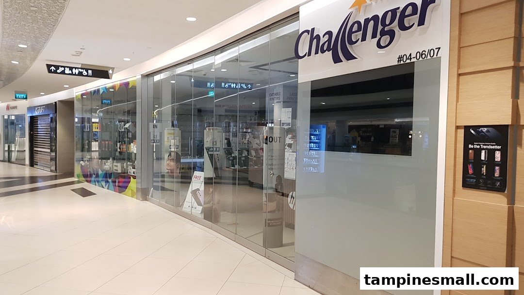 The glass storefront of Challenger, an electronics and IT store, located in a shopping mall.