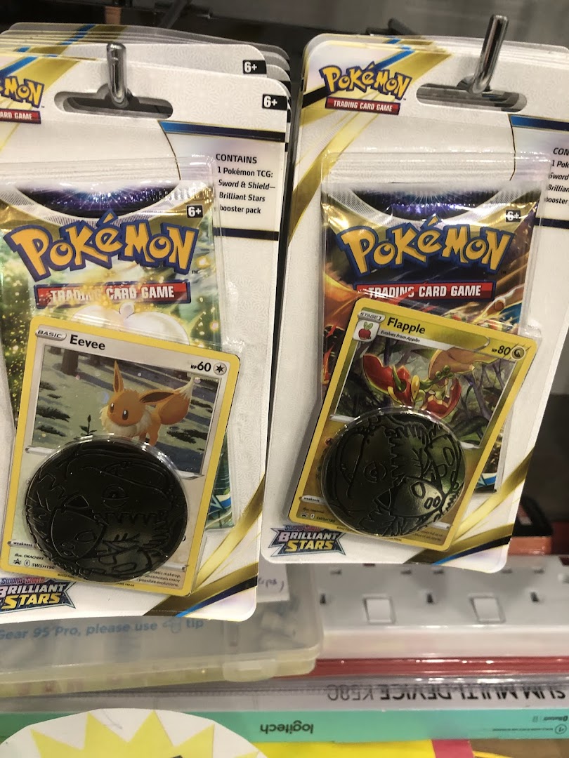 Close-up of Pokémon Trading Card Game booster packs featuring Eevee and Flapple.