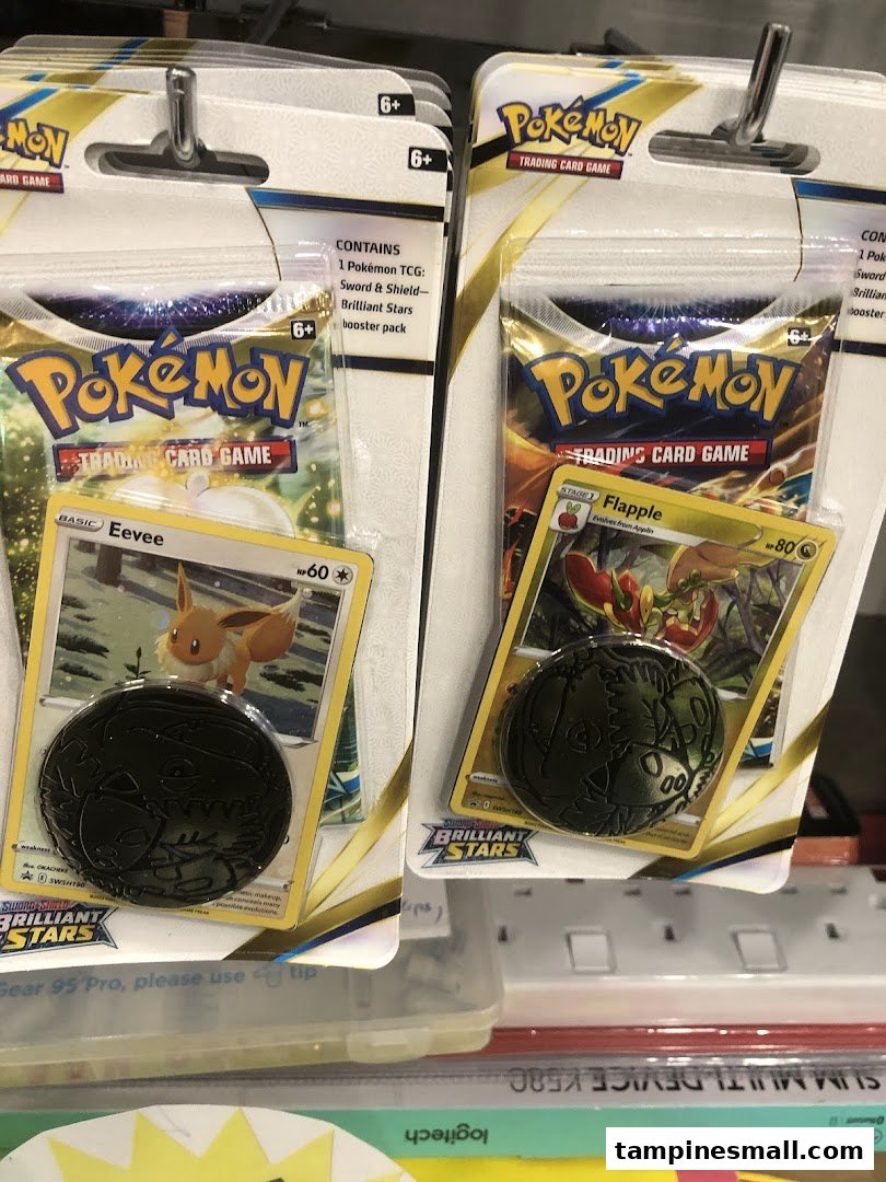 Close-up of Pokémon Trading Card Game booster packs featuring Eevee and Flapple.