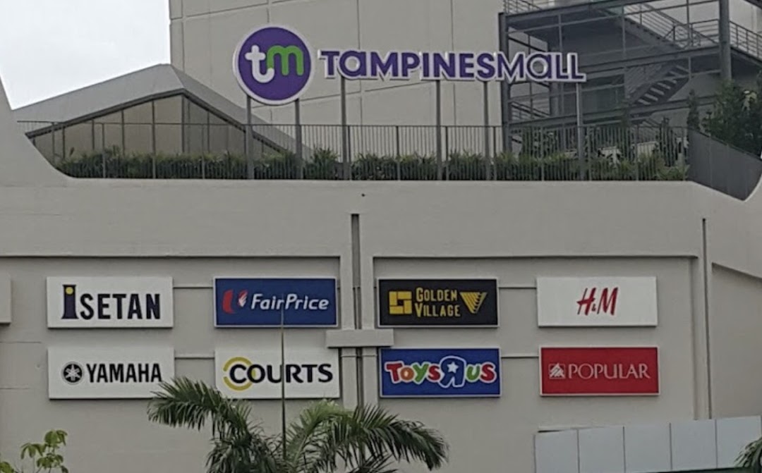 Exterior view of Tampines Mall showcasing various prominent retail and entertainment store signs.