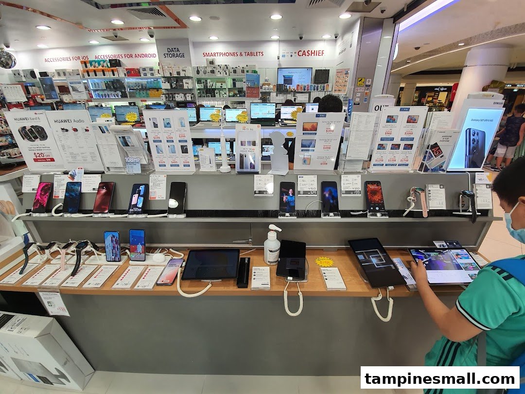 Interior view of Challenger electronics store showcasing smartphones, tablets, and accessories on display.