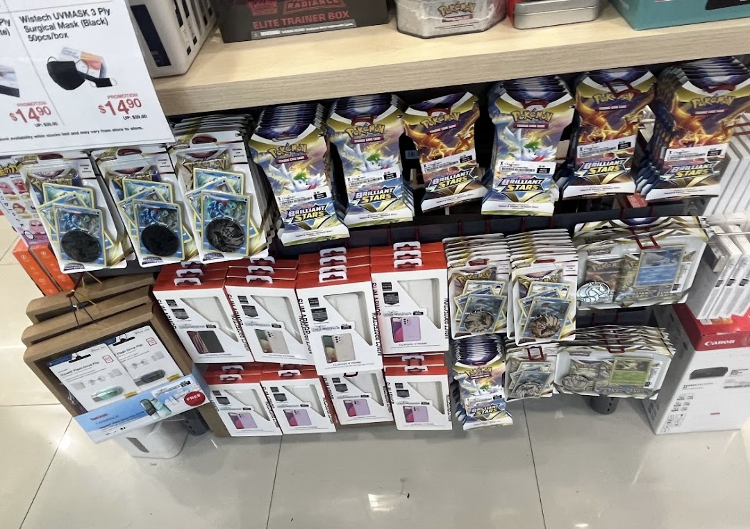 A retail display featuring Pokémon trading cards, phone cases, and surgical masks on shelves.